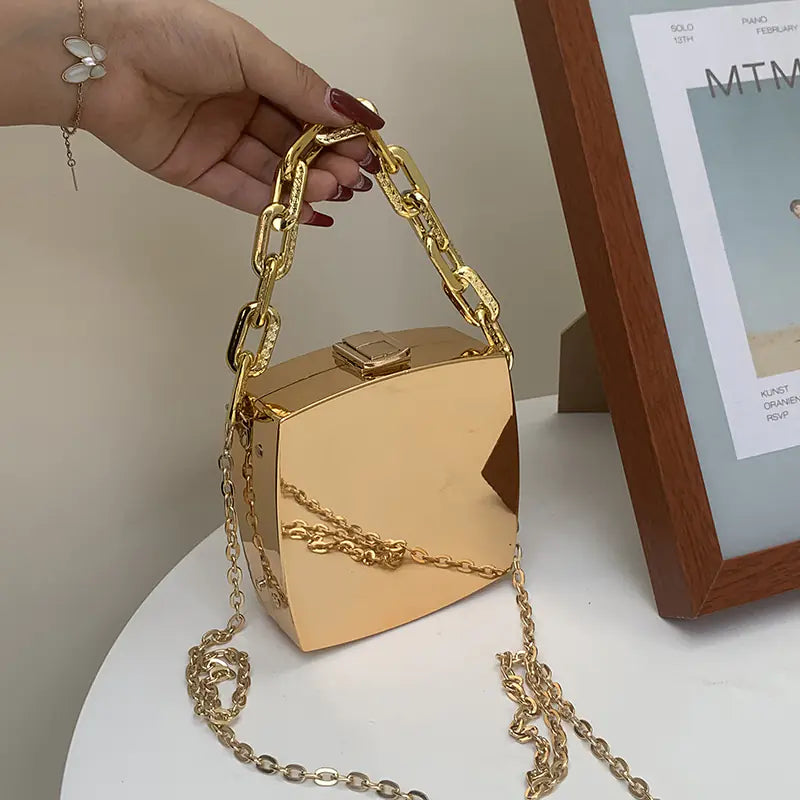 Metal Luxe Box Clutch featuring a thick gold tone chain